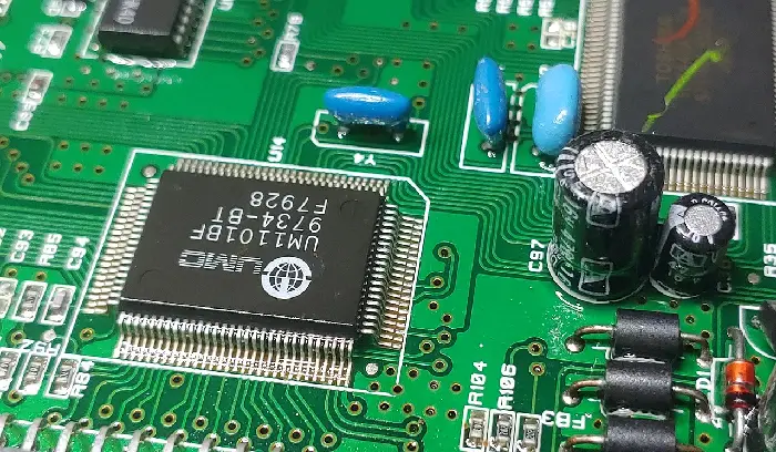 A close up of the electronics on a green board