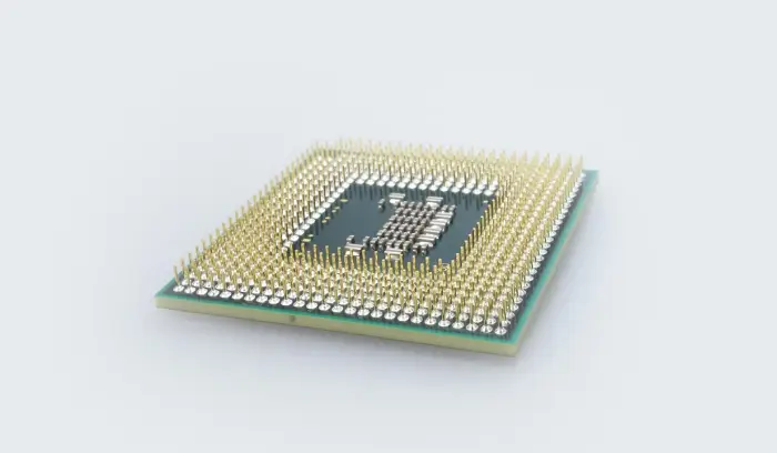 A computer processor with many pins on it.