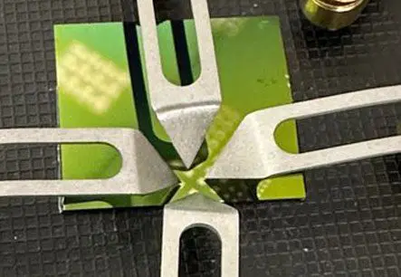 A close up of the cutting tool on a green card